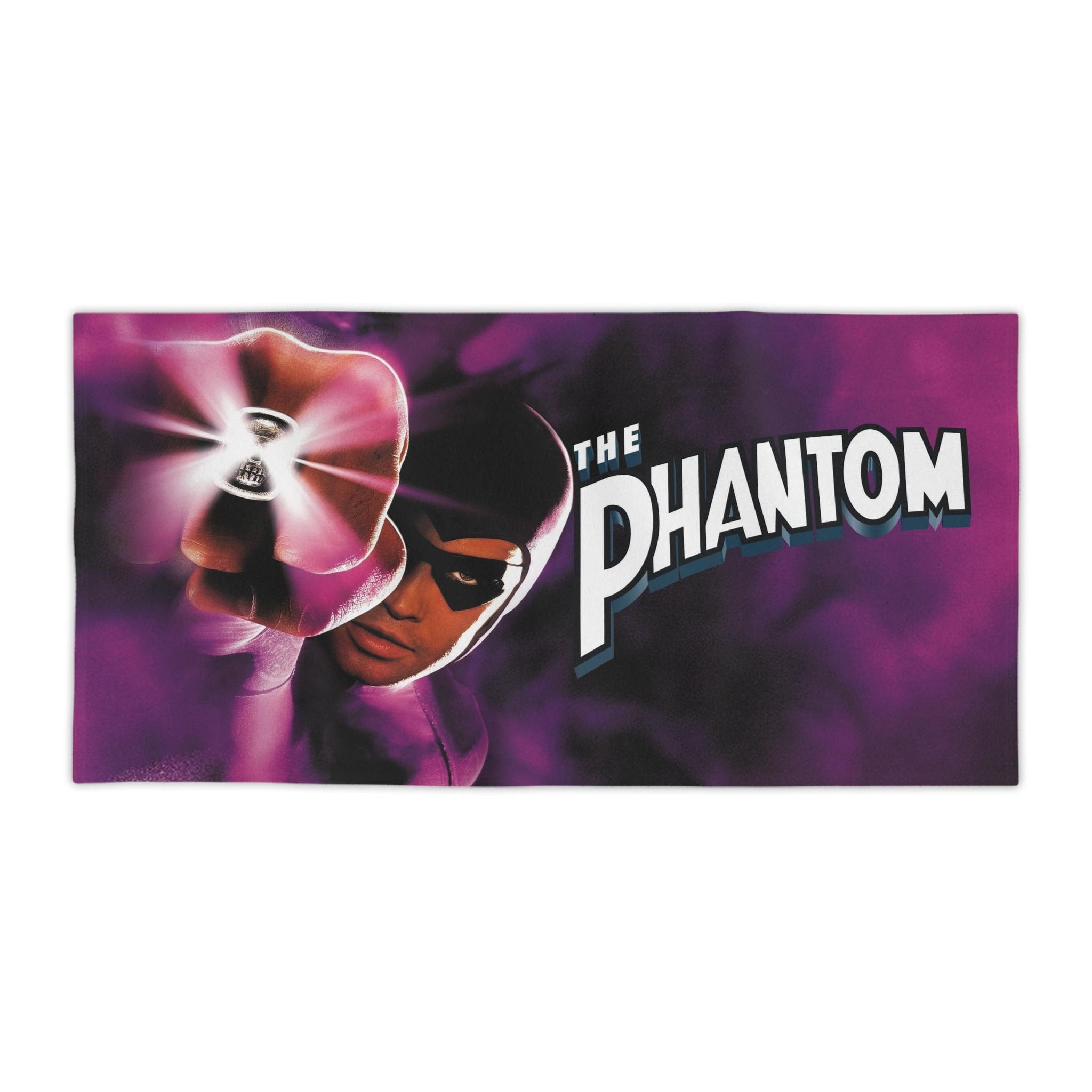 Vibrant purple beach towel featuring Billy Zane as The Phantom (1996), showcasing his glowing skull ring and the movie logo against a smoky background.