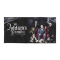Black beach towel featuring a high-quality print of the full Addams Family cast seated in a gothic mansion setting with the movie logo on the left.