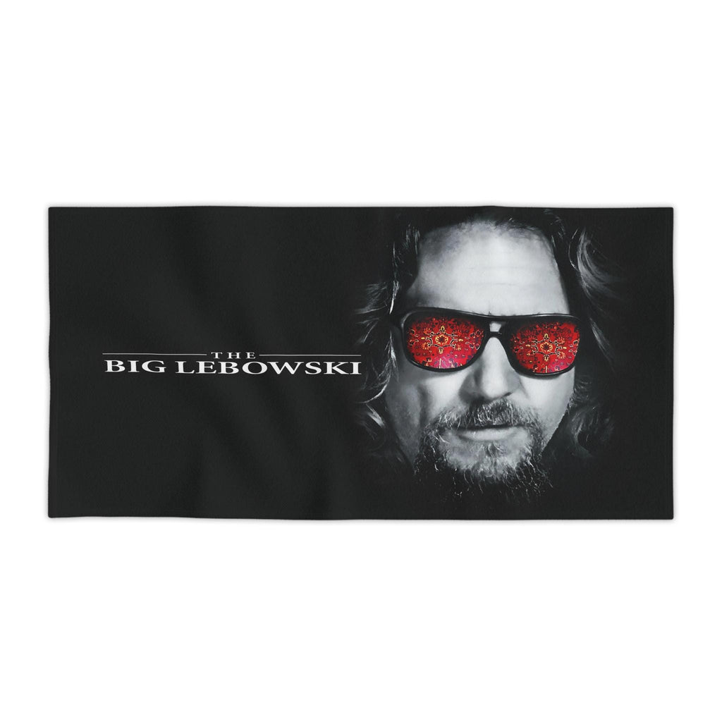 Black beach towel featuring a high-detail print of The Dude from The Big Lebowski with a red rug pattern reflected in his sunglasses.