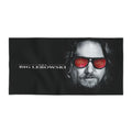 Black beach towel featuring a high-detail print of The Dude from The Big Lebowski with a red rug pattern reflected in his sunglasses.