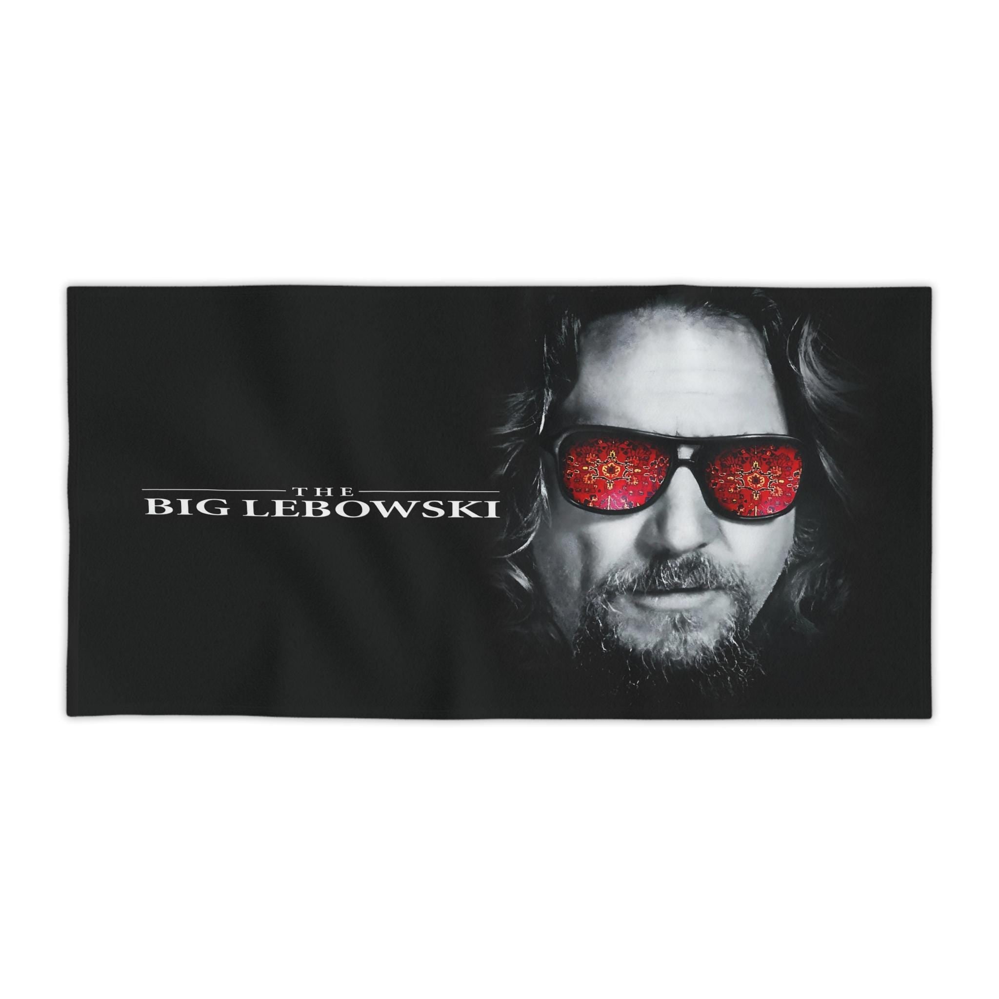 Black beach towel featuring a high-detail print of The Dude from The Big Lebowski with a red rug pattern reflected in his sunglasses.
